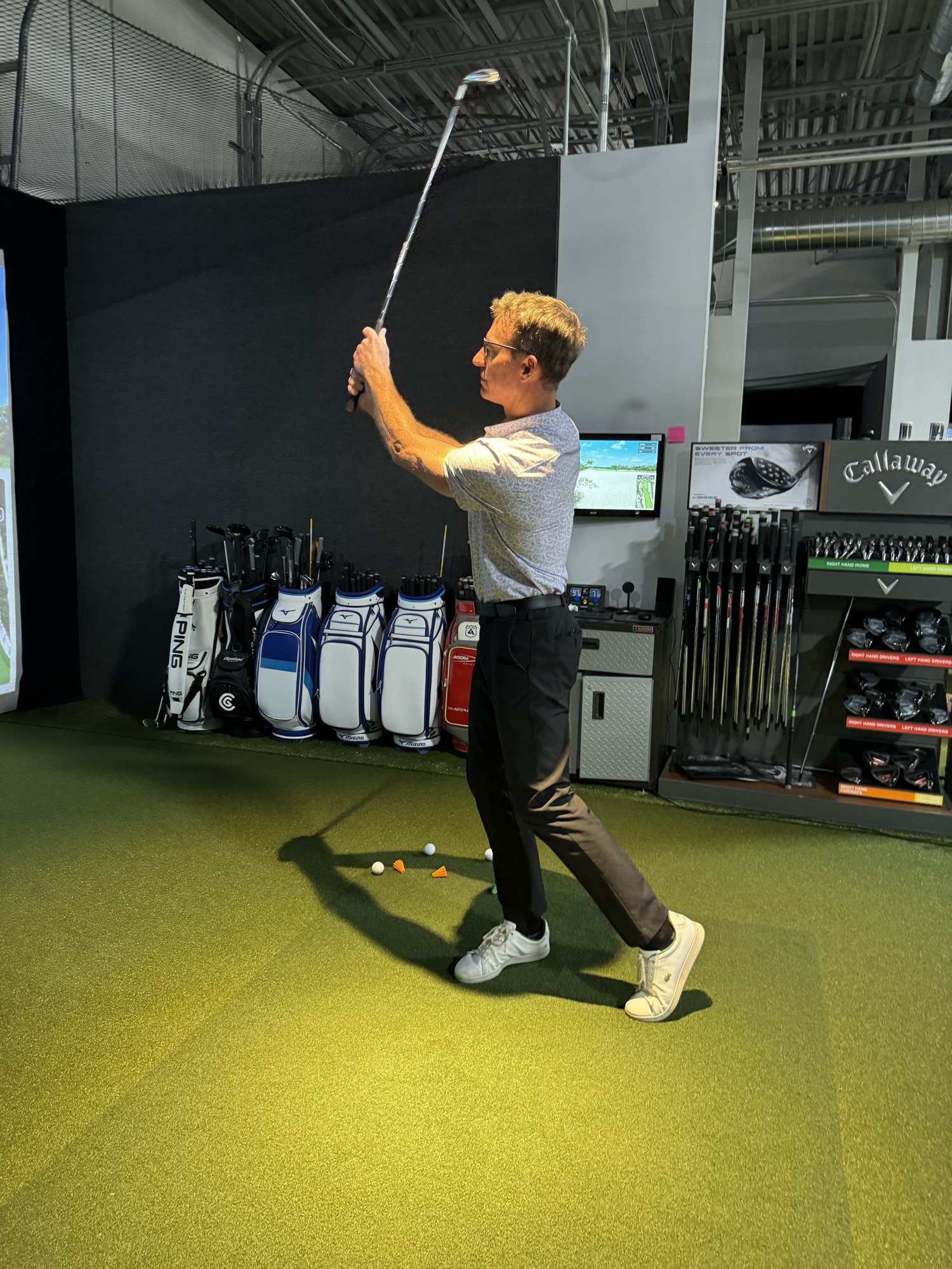 A golfer mid-swing on a Central Ohio course at golden hour — the moment the dressing suite is designed around